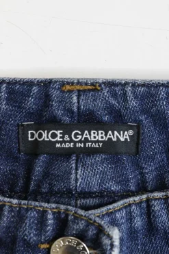 Washed indigo cotton denim low-rise bootcut jeans with whiskering details at hip level