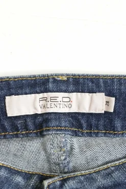 Washed indigo cotton-blend denim low-rise bootcut jeans featuring diamante V-logo plaque patch pockets