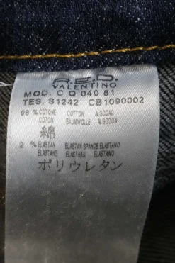 Washed indigo cotton-blend denim low-rise bootcut jeans featuring diamante V-logo plaque patch pockets