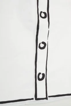White cotton trompe l'oeil mini skirt with graphic sketched details and two back patch pockets
