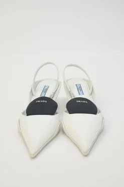 White fabric and rubber pointed-toe slingback court pumps with contrasting logo tongue