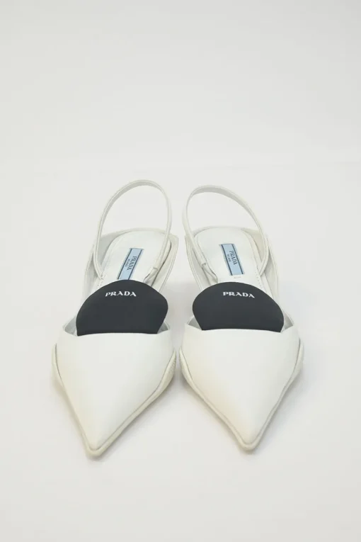 White fabric and rubber pointed-toe slingback court pumps with contrasting logo tongue