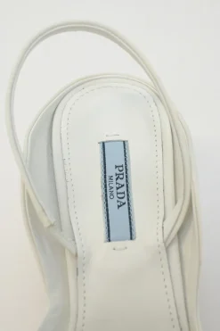 White fabric and rubber pointed-toe slingback court pumps with contrasting logo tongue