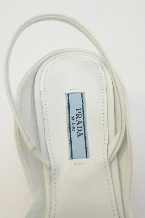 White fabric and rubber pointed-toe slingback court pumps with contrasting logo tongue