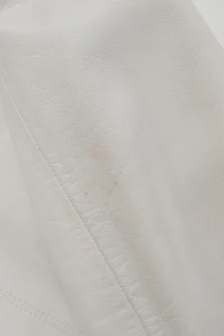 White lambskin single breasted notch lapel tailored jacket with Coco Mark shank buttons