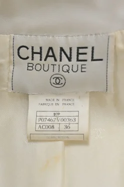 White lambskin single breasted notch lapel tailored jacket with Coco Mark shank buttons