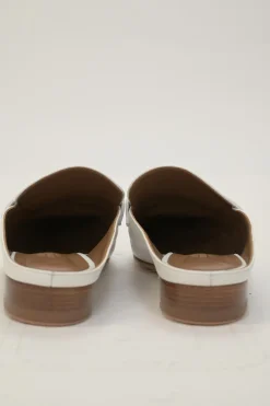 White leather Rivoli slip-on mules featuring palladium-plated H vamp buckle appliqué