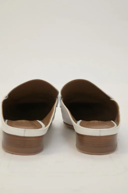 White leather Rivoli slip-on mules featuring palladium-plated H vamp buckle appliqué