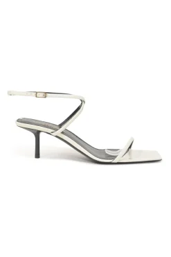 White patent leather low-heeled strappy sandals with criss-cross buckle strap fastening