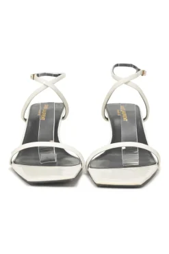 White patent leather low-heeled strappy sandals with criss-cross buckle strap fastening