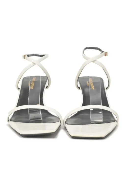 White patent leather low-heeled strappy sandals with criss-cross buckle strap fastening