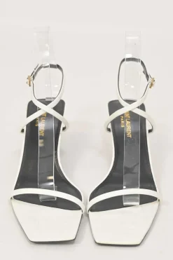 White patent leather low-heeled strappy sandals with criss-cross buckle strap fastening