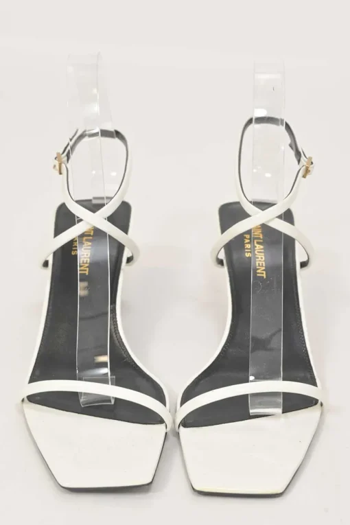 White patent leather low-heeled strappy sandals with criss-cross buckle strap fastening