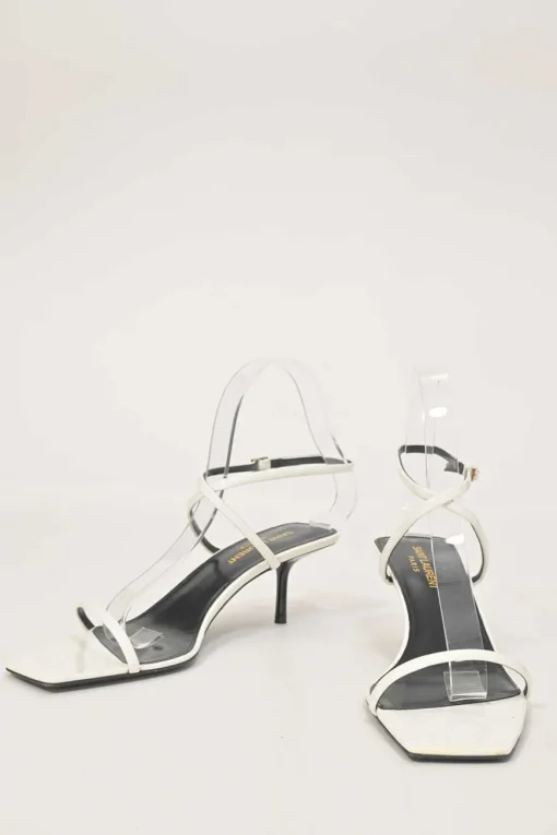 White patent leather low-heeled strappy sandals with criss-cross buckle strap fastening