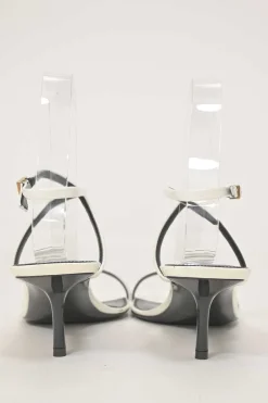 White patent leather low-heeled strappy sandals with criss-cross buckle strap fastening