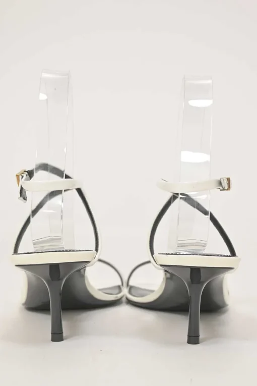 White patent leather low-heeled strappy sandals with criss-cross buckle strap fastening