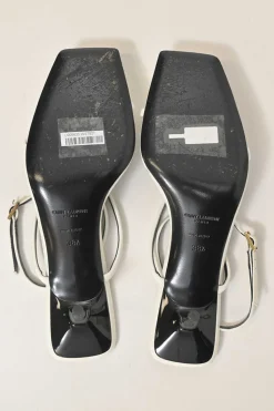 White patent leather low-heeled strappy sandals with criss-cross buckle strap fastening