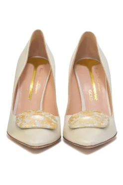 White polished calfskin pointed-toe pumps featuring gold-foiled pebble vamp appliqué