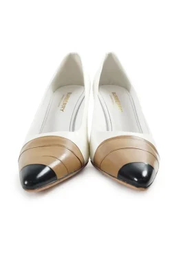 White polished calfskin pointed toe pumps with contrast bandage-style cap toe