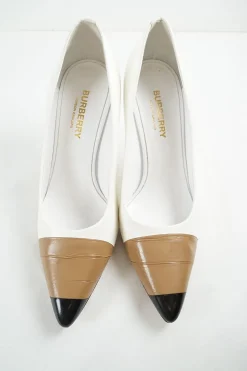 White polished calfskin pointed toe pumps with contrast bandage-style cap toe