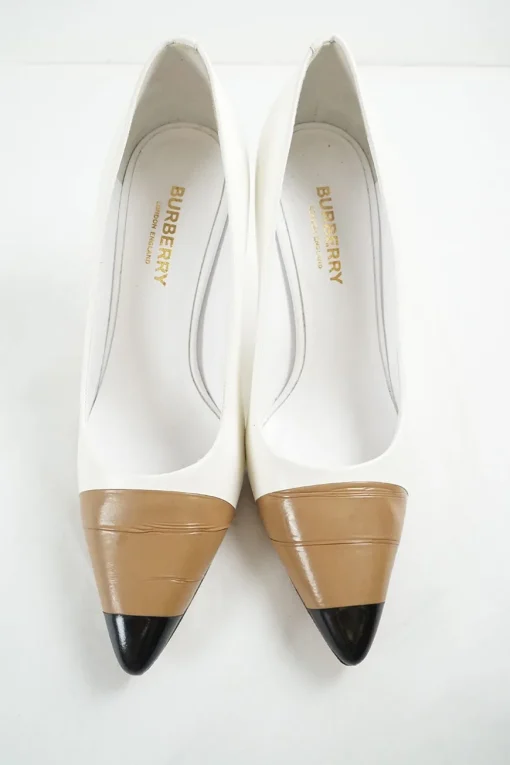 White polished calfskin pointed toe pumps with contrast bandage-style cap toe