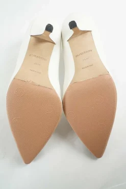 White polished calfskin pointed toe pumps with contrast bandage-style cap toe