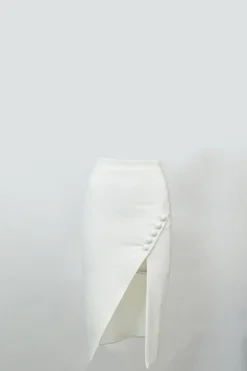 White polyester-blend wrap-effect slit pencil skirt with button-loop show button appliqué