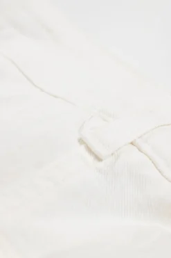 White raw-edge cotton-blend denim high-rise wide-leg jeans with floral-embroidered side seam