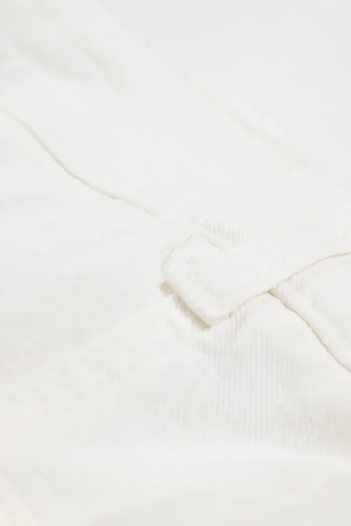 White raw-edge cotton-blend denim high-rise wide-leg jeans with floral-embroidered side seam