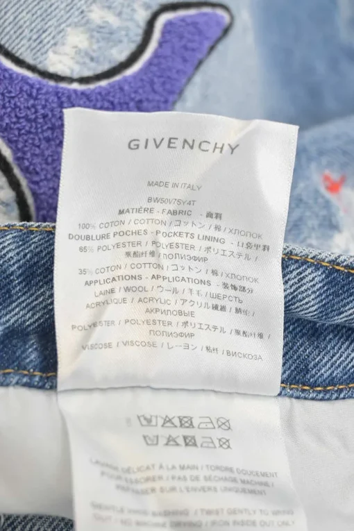 x Disney distressed indigo cotton denim high-rise straight leg LNY jeans featuring Oswald &amp; Ortensia novelty patch appliqué