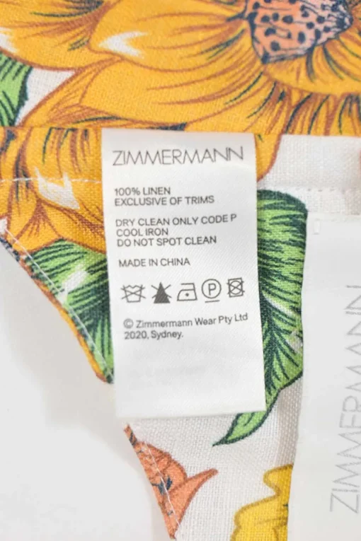 Yellow linen Poppy print two-piece set featuring off-shoulder ruffle bustier top and belted wide-leg pants