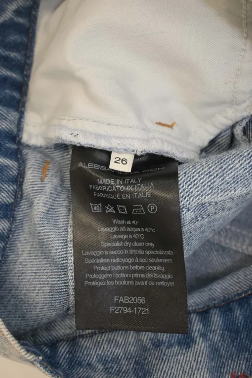 Acid-wash indigo cotton denim pull-on mini skirt with exposed crystal shank button placket