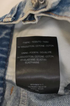 Acid-wash indigo cotton denim pull-on mini skirt with exposed crystal shank button placket