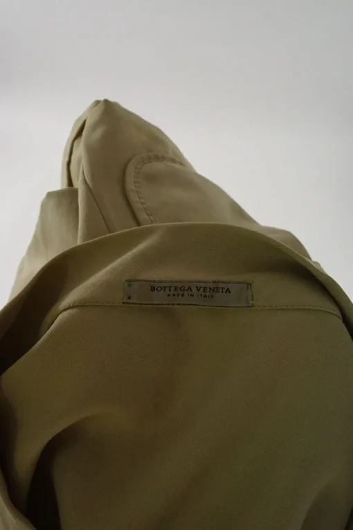 Beige band collar swing-style shift tunic with darted neckline and draped patch pockets