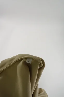 Beige band collar swing-style shift tunic with darted neckline and draped patch pockets