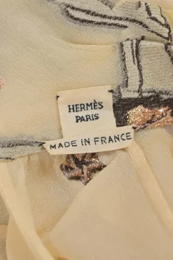 Beige embroidered silk-blend high collar keyhole-front blouse featuring trapeze artist novelty motif
