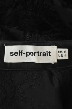 Black acrylic-blend semi-sheer floral fil coupé peek-a-boo mock neck trumpet sleeve blouse