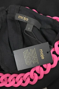 Black and fluo pink chainlink-trimmed crewneck pullover cap sleeve blouse with keyhole back