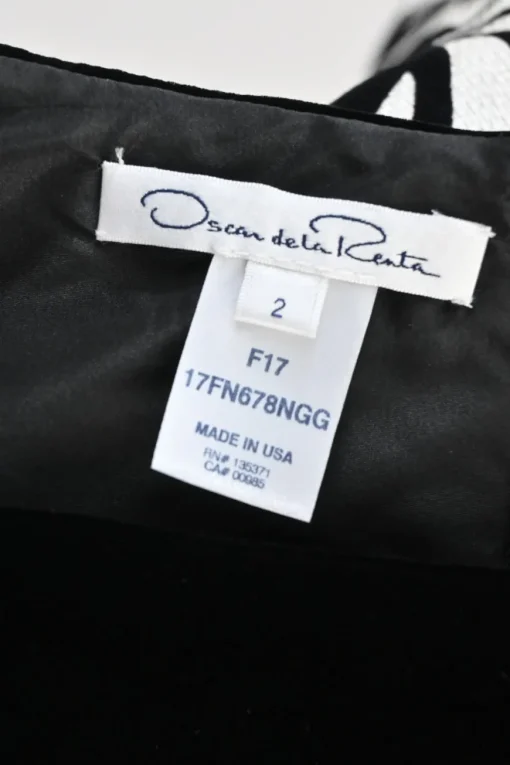Black brooch-embellished two-tone paneled rayon-blend floral Dobby bateau neck sleeveless sheath dress