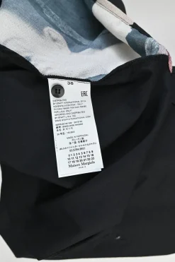 Black cotton poplin point collar dolman short sleeve button-front swing shirt with printed side inserts