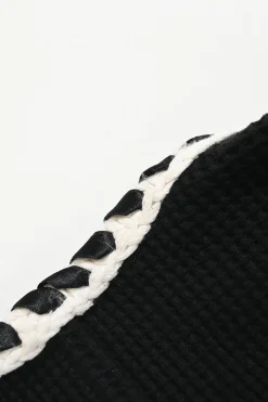 Black cotton raschel knit collarless button-front cardigan jacket with contrasting braided edges and Coco Mark shank buttons