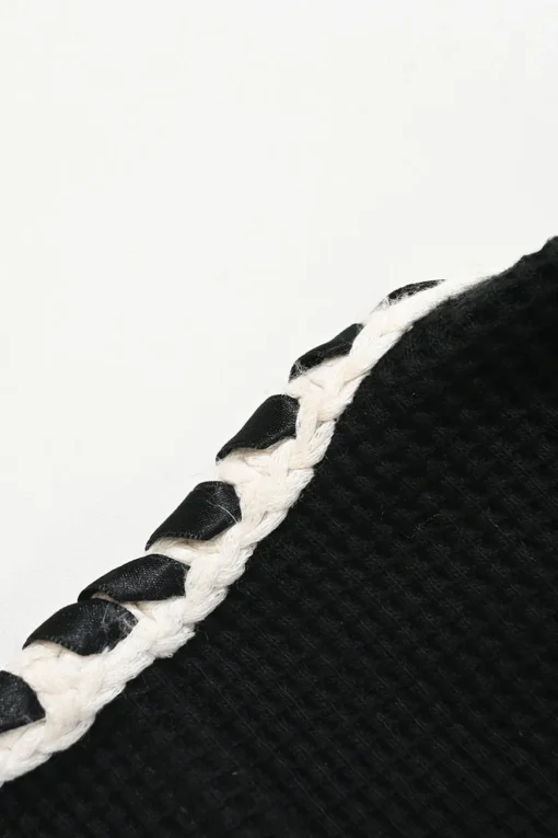 Black cotton raschel knit collarless button-front cardigan jacket with contrasting braided edges and Coco Mark shank buttons