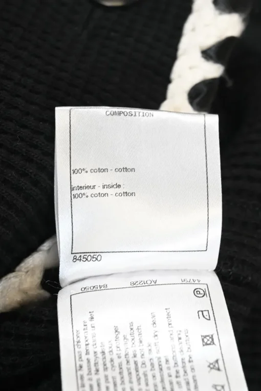 Black cotton raschel knit collarless button-front cardigan jacket with contrasting braided edges and Coco Mark shank buttons