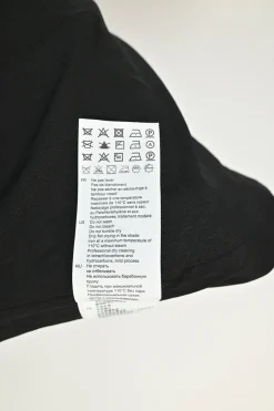 Black cotton-blend houndstooth tweed bi-layer mini dress with scalloped collar and logo shank buttons