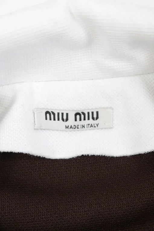 Black cotton-blend two-tone half-zip spread notch collar polo with logo chest patch