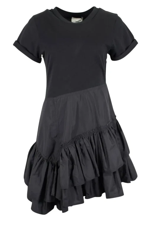 Black crew neck with folded hem short-sleeved mini dress. Adorned with layered flared pleated skirt and feature zipper closure on the side