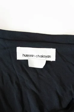 Black draped rayon-blend knit top with adjustable  buckle strap fastening
