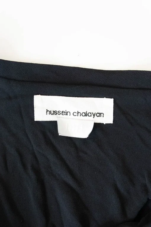 Black draped rayon-blend knit top with adjustable  buckle strap fastening