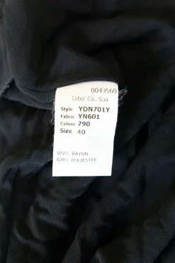 Black draped rayon-blend knit top with adjustable  buckle strap fastening