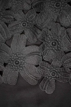 Black off-shoulder top with black flower applique chest flap